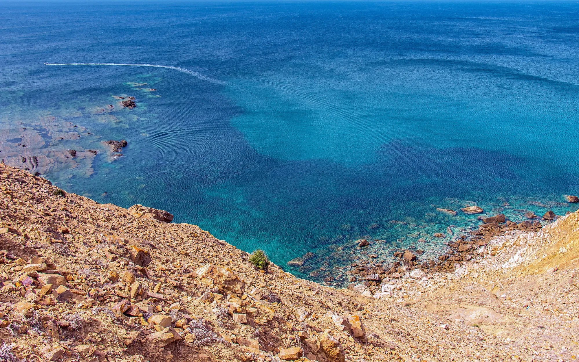 A turquoise cove below the cliffs of El Haouaria